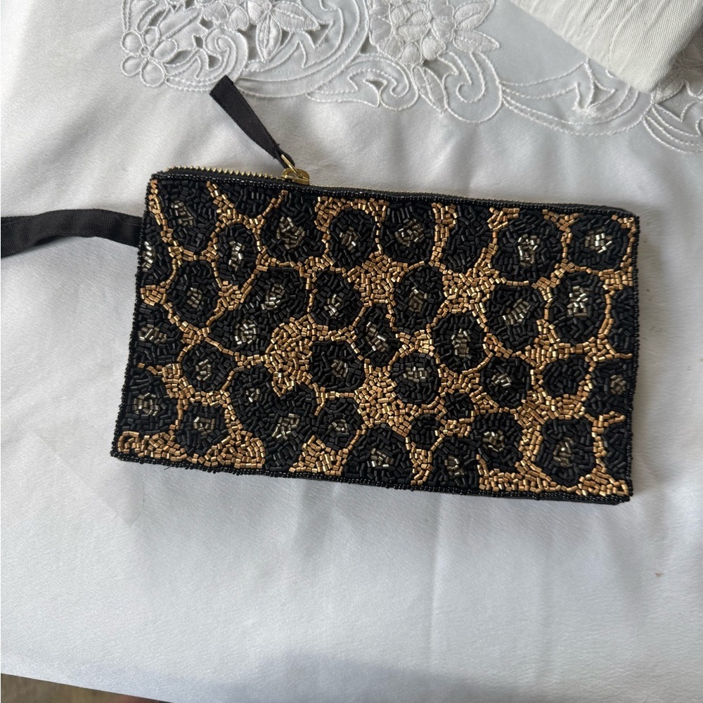 Wristlet lady zip up beaded black and gold. Excellent condition. Zip top handle.